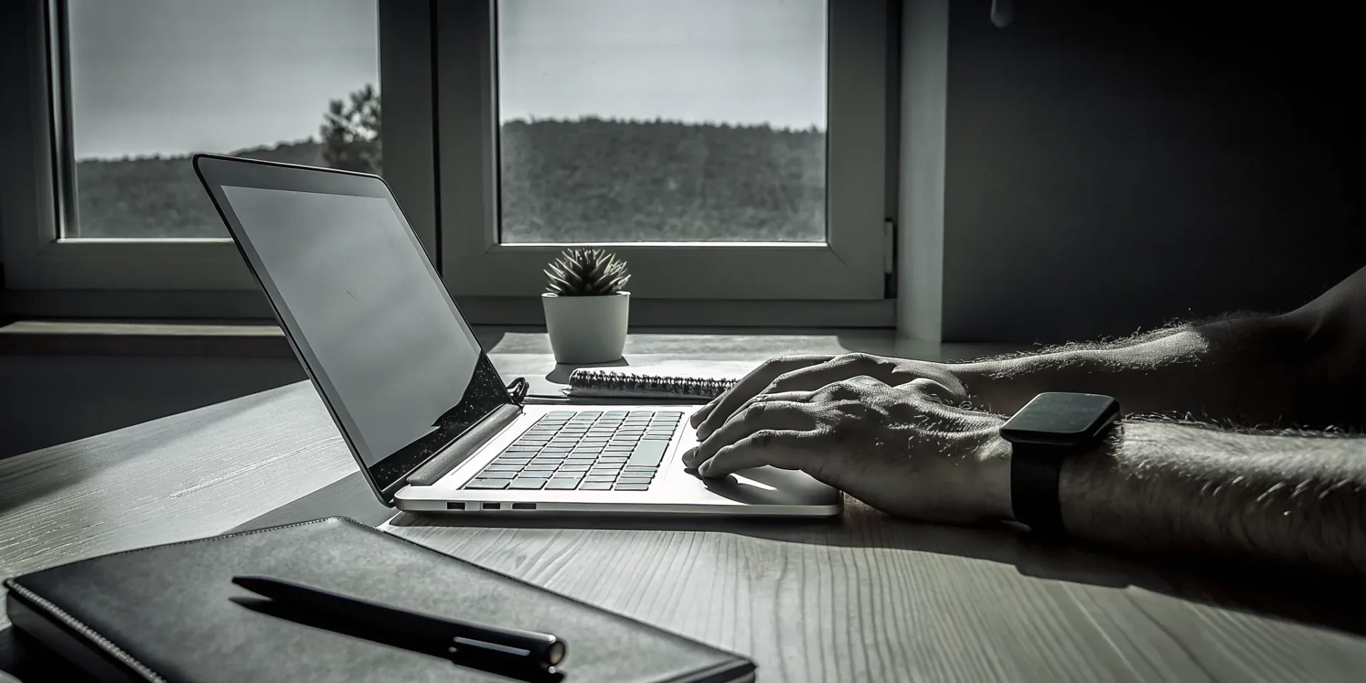 Hands typing on a laptop to enroll in a deep tissue massage course.